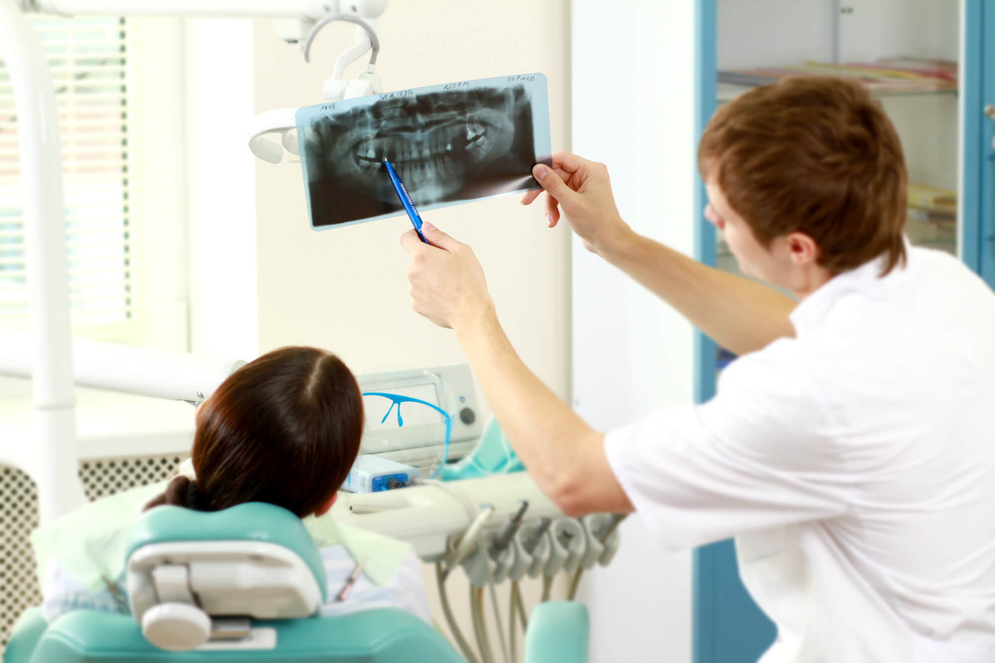 dentist and female patient looking at x-rays to see if she needs a root canal in richmond va